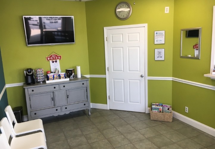 Waiting room with light green walls in Saint Peters dental office