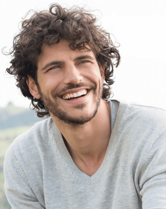 a man with dental bridges smiling in Saint Peters