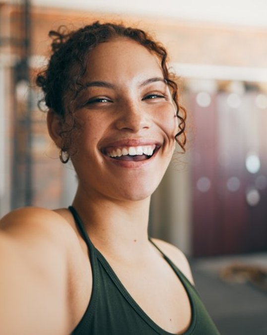 a woman smiling with her new dental bridges