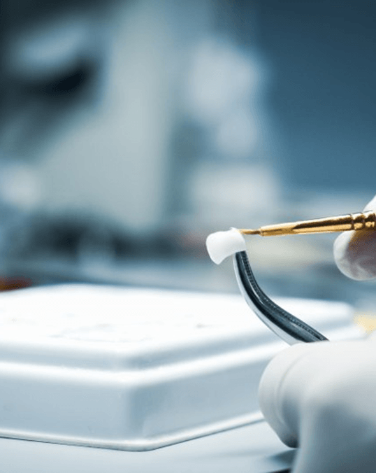 a dental technician preparing a dental crown in Saint Peters