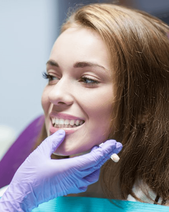 a patient smiling after receiving a dental crown