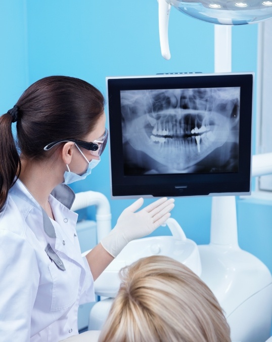 Dentist showing a patient their digital dental x rays