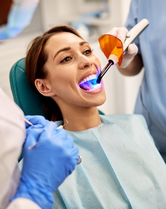 Woman in dental chair receiving direct bonding