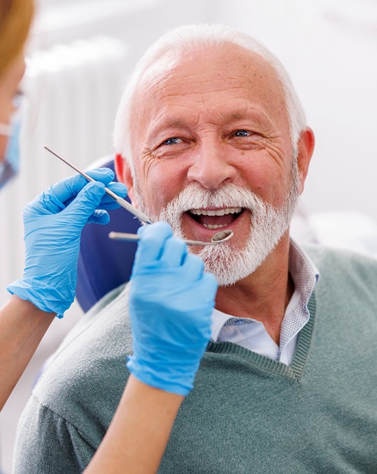 Man smiles at dentist