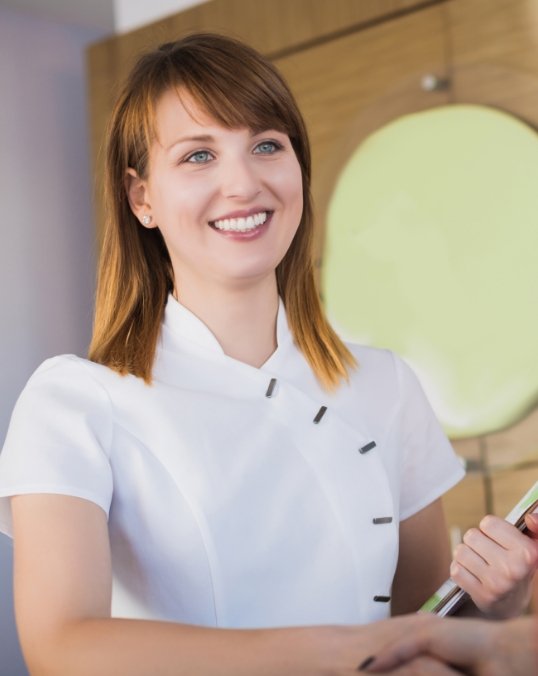 Dental team member holding a clipboard