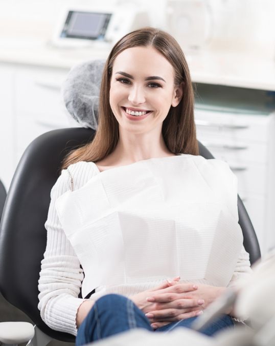 Smiling brunette woman in dental chair