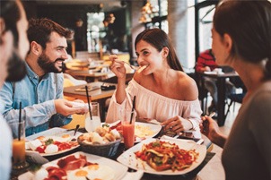 Group of friends eating meal at restaurant