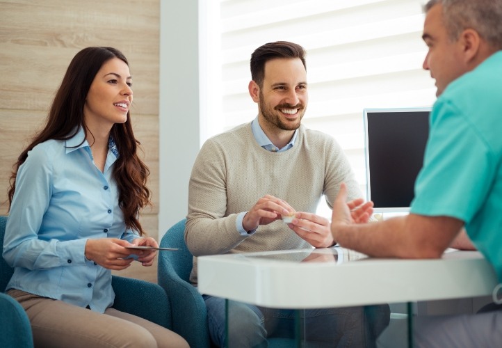 Man and woman talking to dentist about dental special offers in Saint Peters