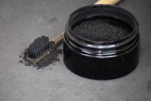 toothbrush with activated charcoal powder on it
