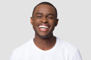 man with beautiful smile after getting a smile makeover