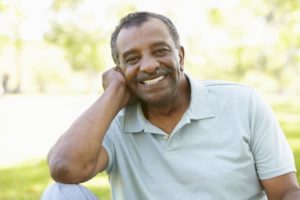older man smiling with dental implants