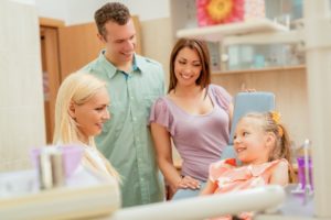 Young girl with parents at dental office