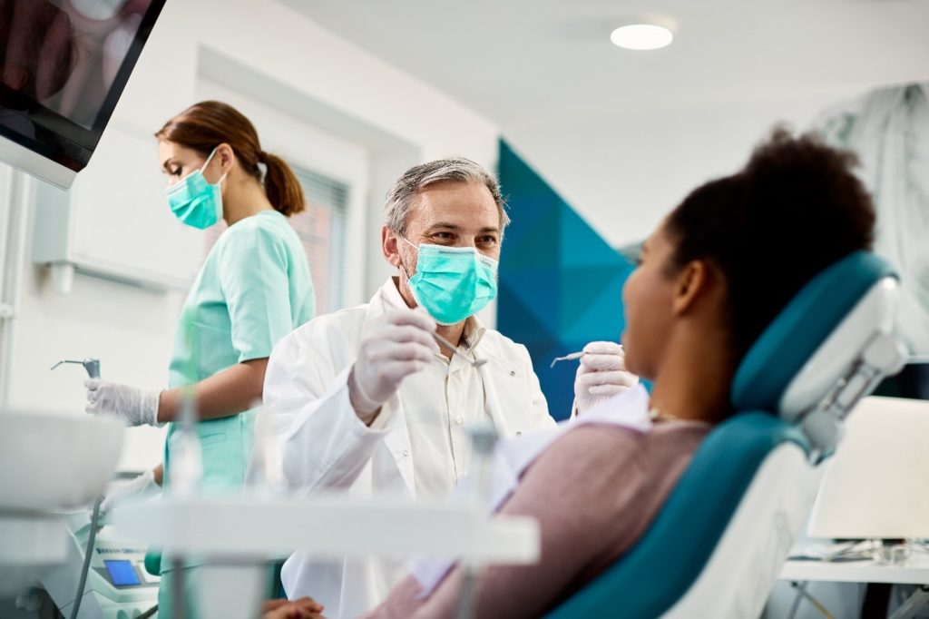 Dentist smiling at patient during checkup