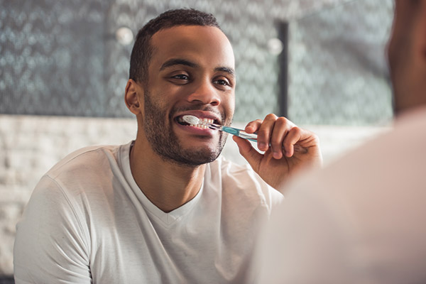 person preparing to brush their teeth for good oral health