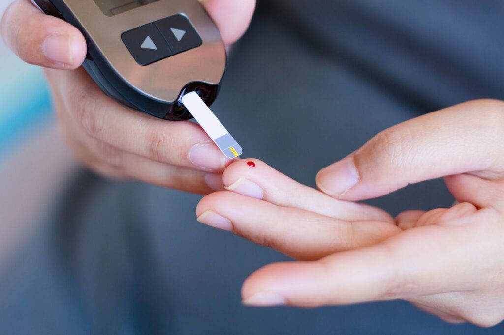 Closeup of someone testing blood glucose levels